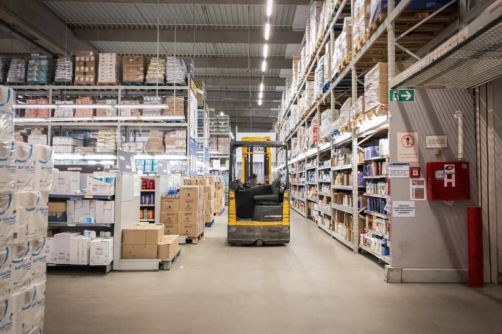 Inventory management in a factory with boxes on shelves.