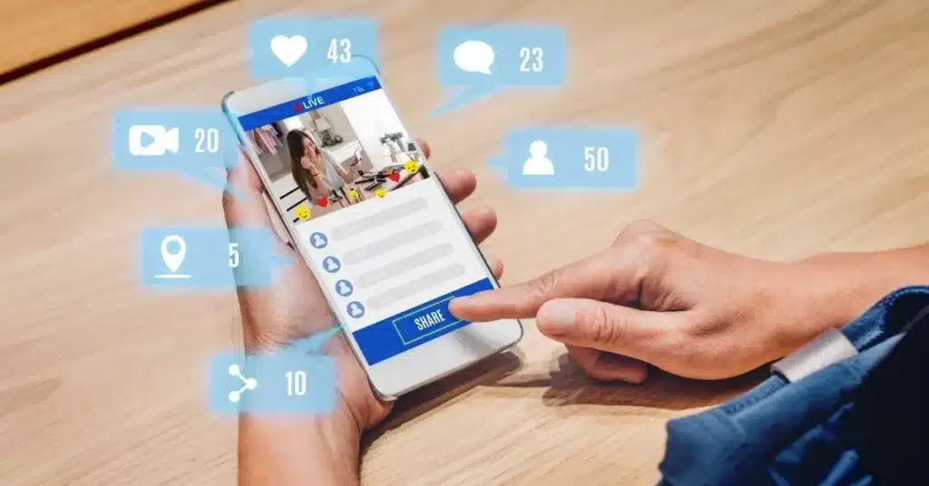 Person watching influencer livestream on smartphone, highlighting social media’s role in celebrity marketing.